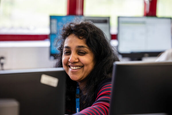 Media student smiling at computer