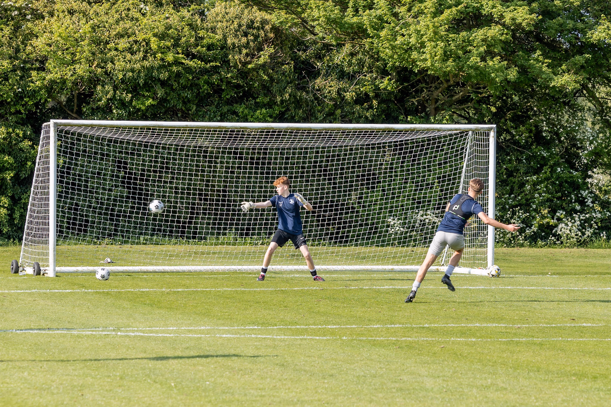 Sports students playing football on the college field.