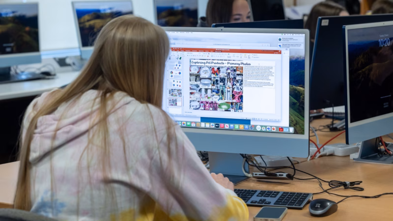 Digital design students creating artwork on computers.