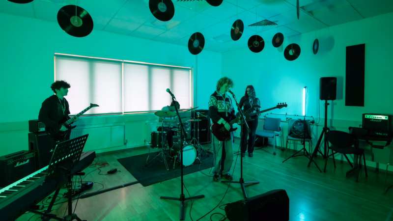 Music students performing in a college recording studio.