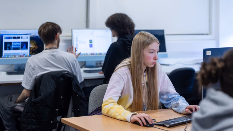Computing students working on digital projects in class.