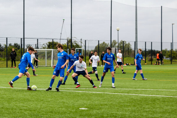 MK College group football team playing a match