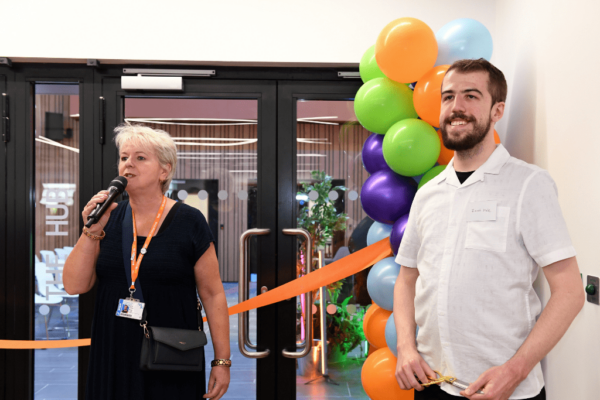 CEO of MK College Group and SCIoT student Jacob Vale standing in front of colourful balloons and an orange ribbon at the opening of the South Central Institute of Technology building in Bletchley,