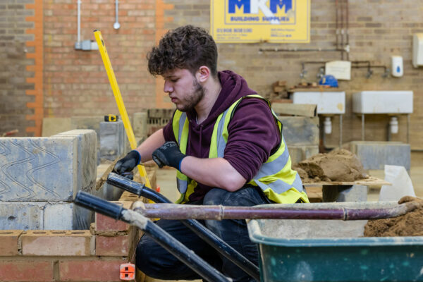 Bricklaying student learning how to lay bricks