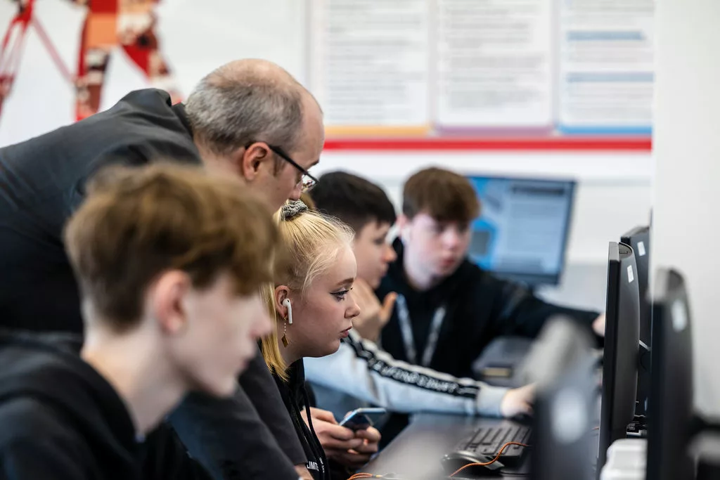 Students sat behind computers, working together