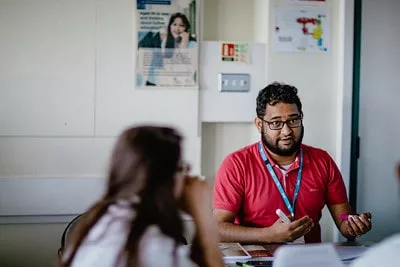 Teacher and student in a classroom talking