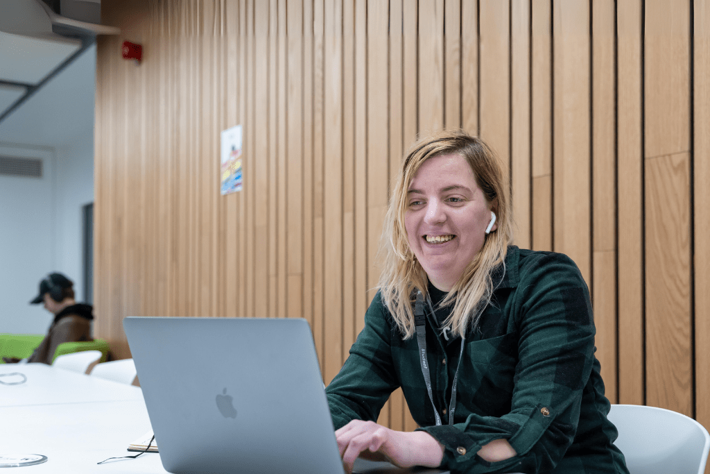 Female student using laptop at desk