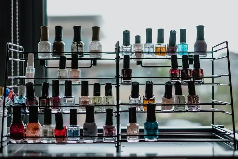 Nail polish bottles on a wire shelf