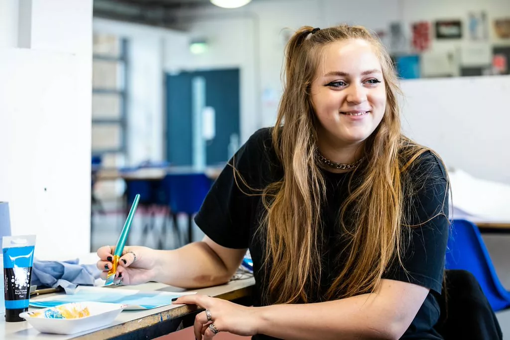 Female art students painting a picture