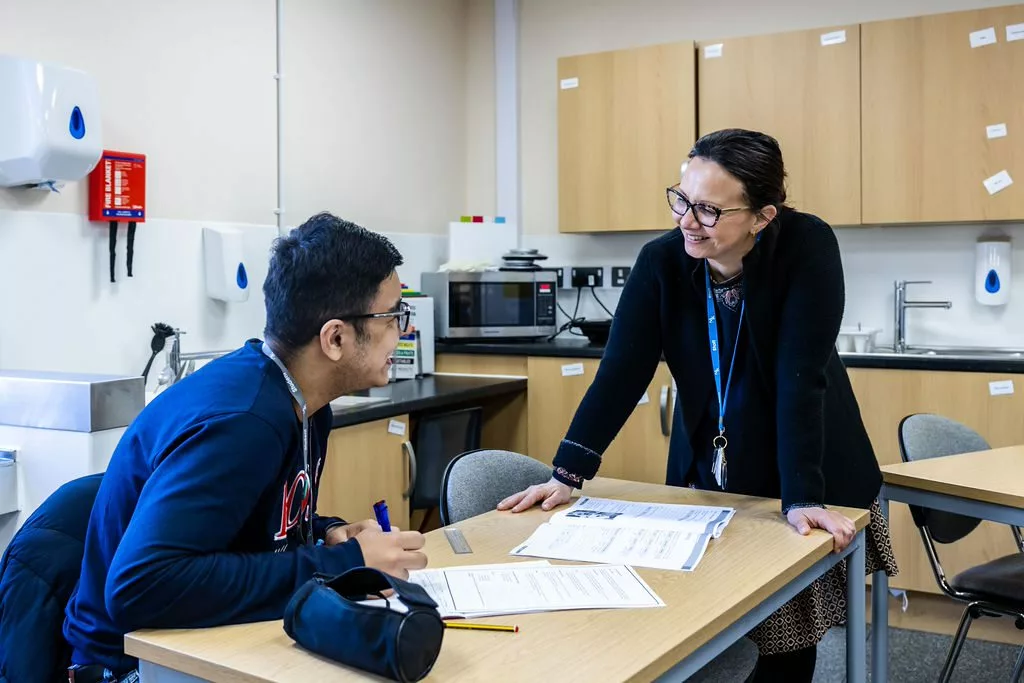 Inclusive learning students talking with his teacher