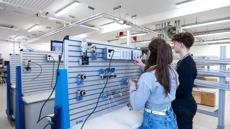 Engineering students working on machinery