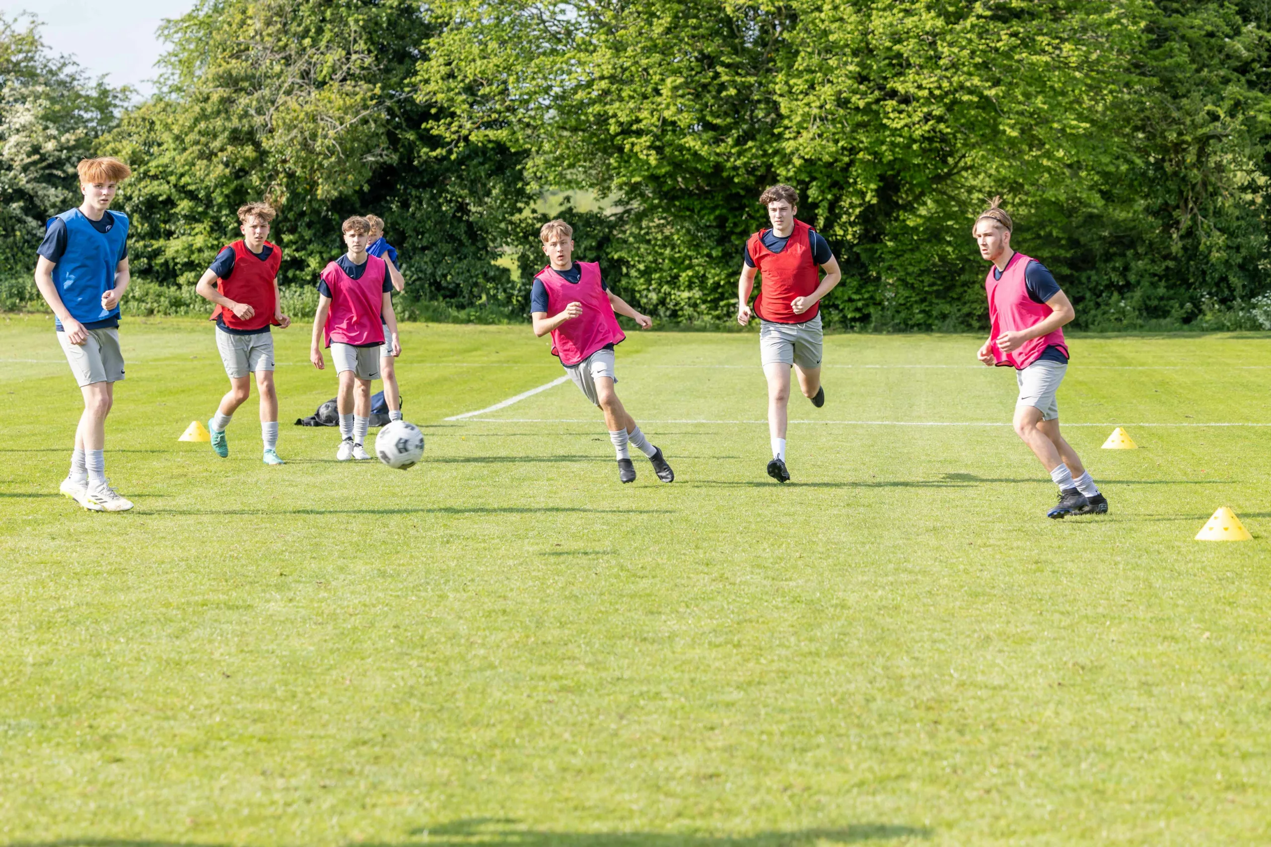 7 male students playing football