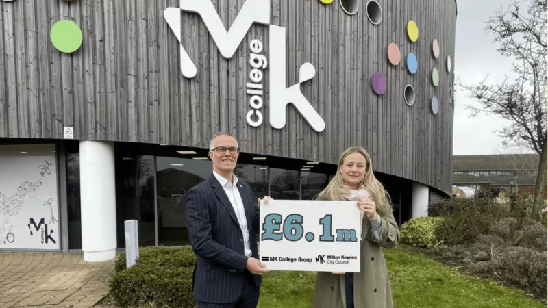 MK College Group's COO Jason Mansell with MK City Councillor Lauren Townsend. Jason and Lauren are standing outside Milton Keynes College's Chaffron Way campus, holding a sign that says £6.1m.