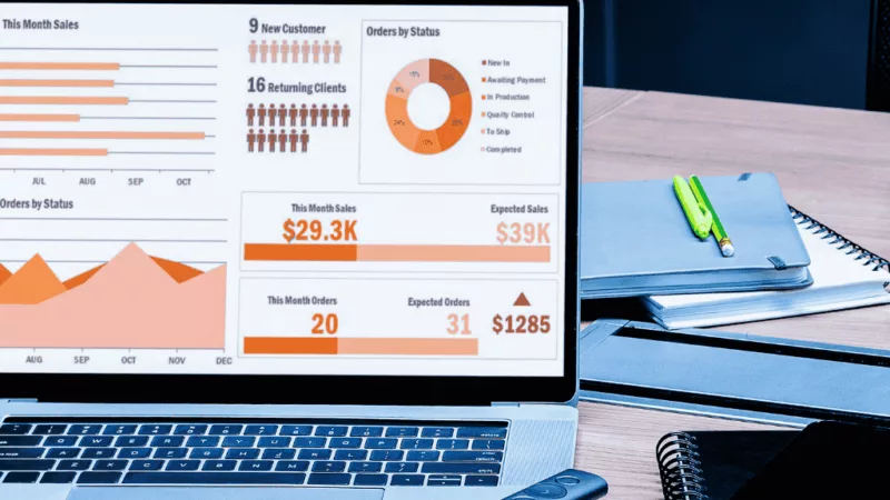 A financial report and business analytics displayed on a laptop screen.