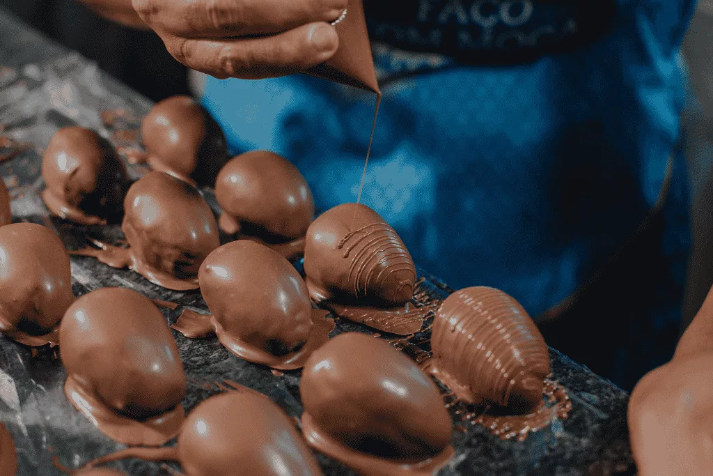 Handmade chocolate – Close-up of chocolate arranged neatly on a blue surface.