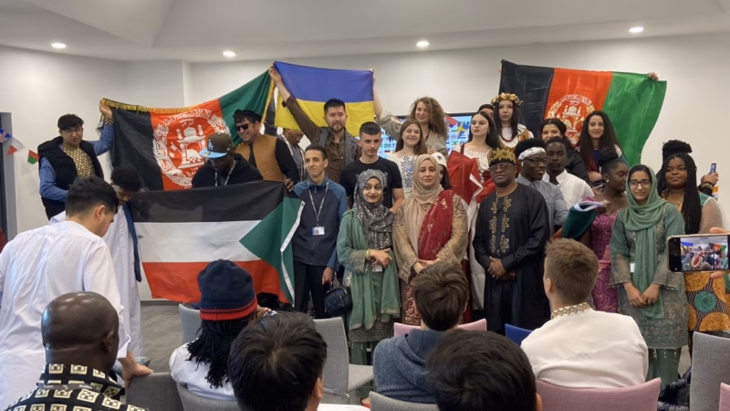 Students holding up Sudan's, Afghanistan's and Ukraine's flags