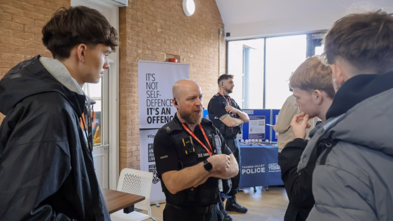 Students speaking to a Thames Valley Police officer during Safety Day