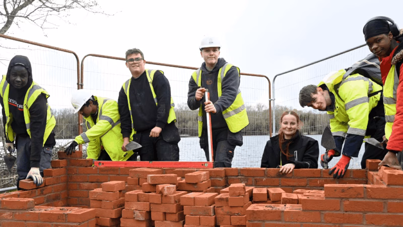 Construction students at MK College building a bird hide at the Blue Lagoon, as part of the College in the Community Day.