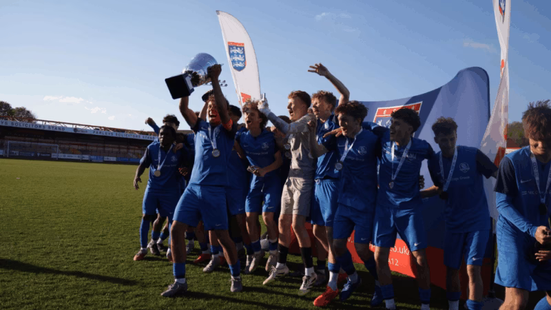 Students from the MK College Football Academy with the National Colleges Football Association National Cup trophy.